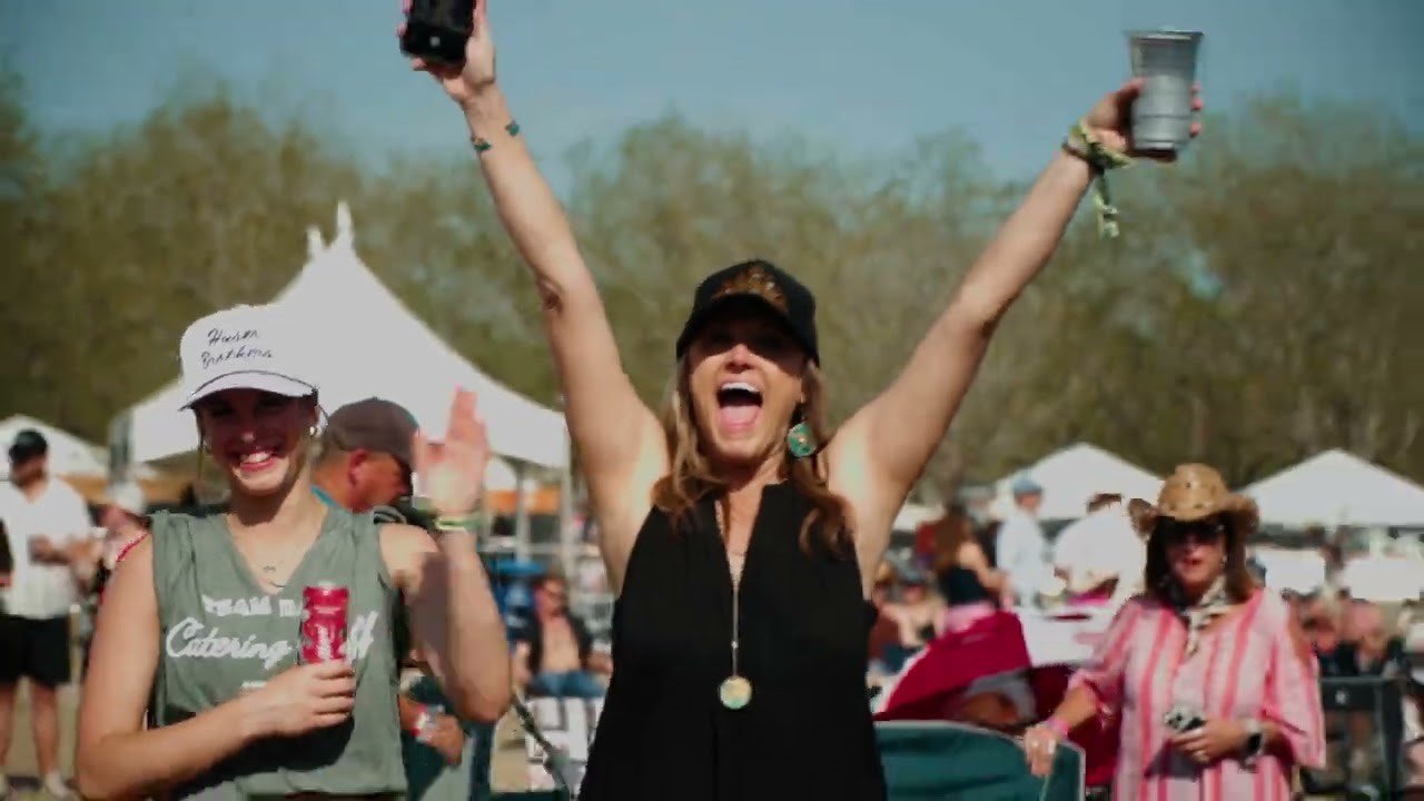 Festival crowd with arms raised at Cattle Country Fest