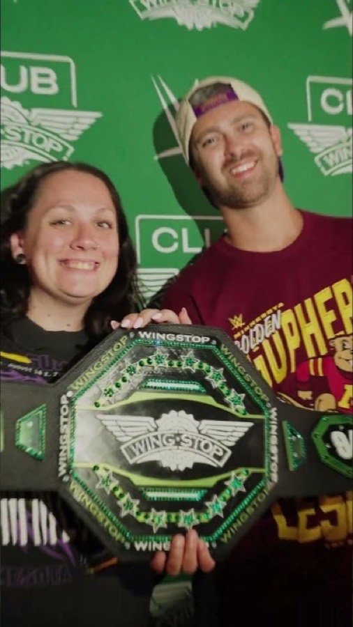 Wingstop championship belt held up at a WWE activation